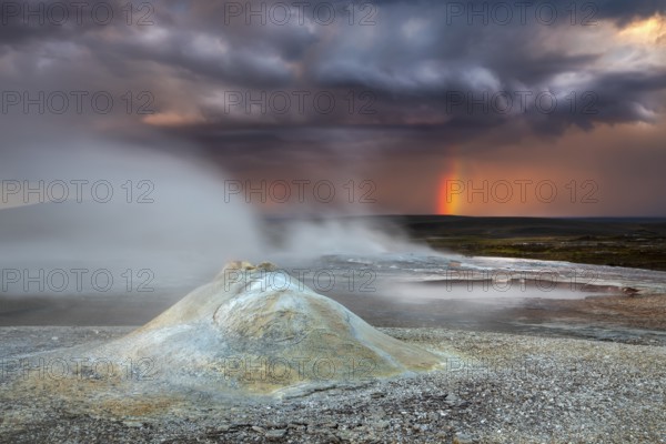 Thunderstorm and rainbow over the Hveravellir geothermal area with natural hot springs and
