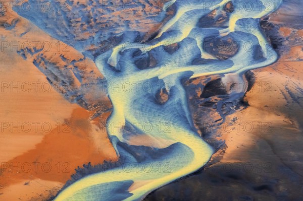 Aerial view of the colorful Þjórsá River, Iceland's longest river, weaving through volcanic