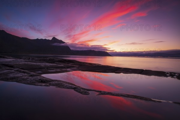 Coastal view in Senja, Norwegian Sea, rugged cliffs and mountains composed mainly of Precambrian