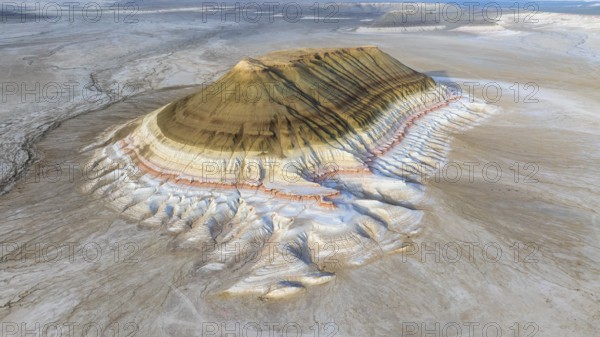 Aerial view of Mount Bokty, isolated sandstone mountain rising above the desert landscape,