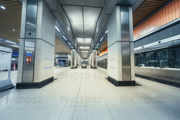 Empty train station with modern architecture, wide corridors and bright lighting conditions,