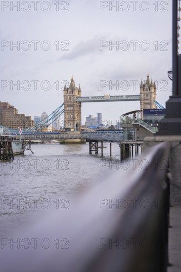 Historic bridge with towers over a river with an urban skyline in the background, Tower Bridge,