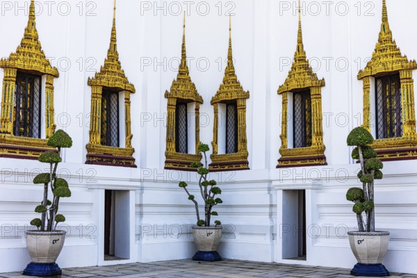 The Grand Royal Palace, richly decorated and gilded windows at the Dusit Maha Prasad throne hall,