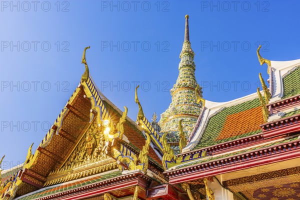 The Grand Royal Palace, Wat Phra Kaeo Buddhist Temple, overlapping roofs with curved chofas, Chedi