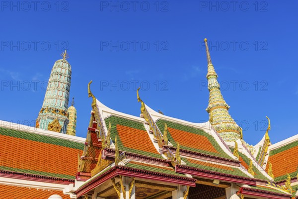 The Grand Royal Palace, Wat Phra Kaeo Buddhist Temple, overlapping roofs with curved chofas, Chedi