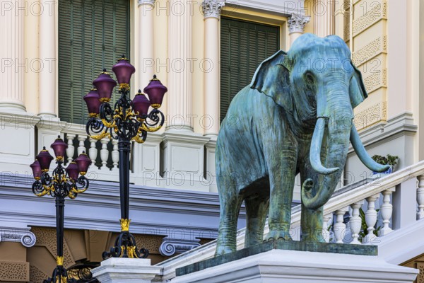 The Grand Royal Palace, an elephant statue and multi-armed lanterns decorate the side entrance of