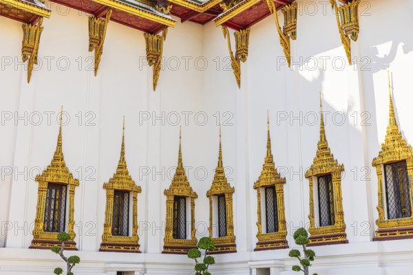 The Grand Royal Palace, richly decorated and gilded windows at the Dusit Maha Prasad throne hall,