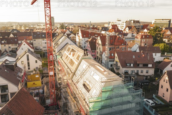 Panoramic view of urban construction on a roof with crane and scaffolding, carpentry, renovation,