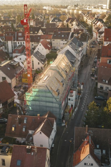 Aerial view of a construction site in a city with an urban environment and roof work, carpentry,