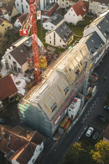 Overview of a large construction site in a residential area during roof renovation, carpentry,