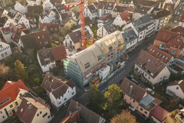 District with a large construction site in the center, taken from above, carpentry, renovation,