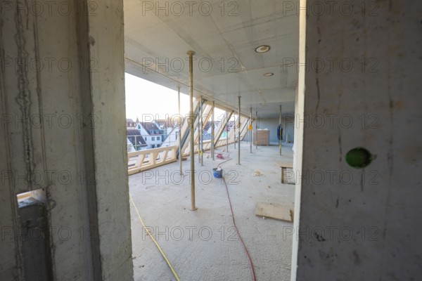 Semi-finished interior of a construction site with exposed structure and supports, carpentry