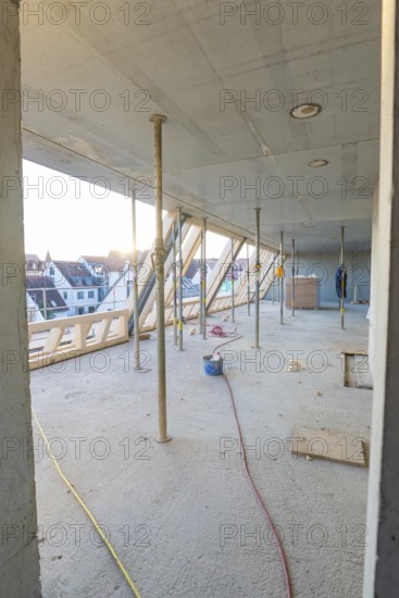 Unfinished interior of a construction site with a view of the residential area, construction site