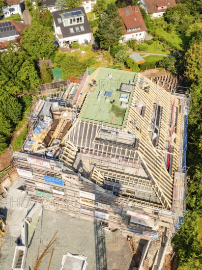 Aerial view of a construction site in a residential area with progressive building construction,