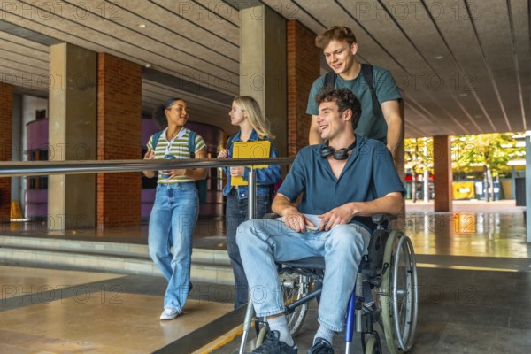 Diverse group of young adult university students walking and talking on campus, with one male