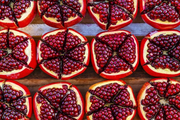 Pomegranate (Punica granatum), halved with red seeds, fruit, food, stand at the Asiatic Riverfront,