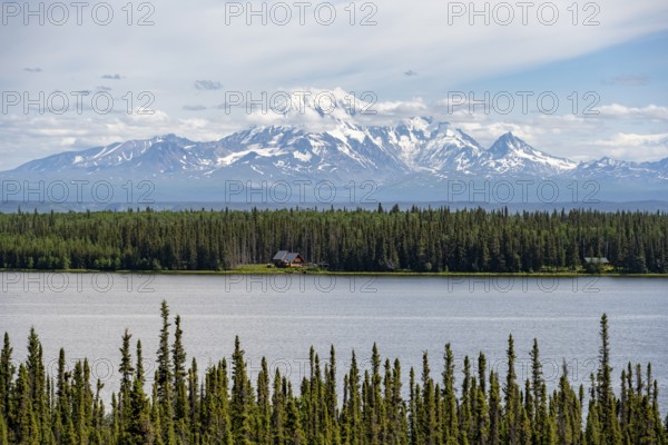House on Lake Willow Lake, Taiga landscape with high glaciated mountain peak Mount Drum, Wrangell