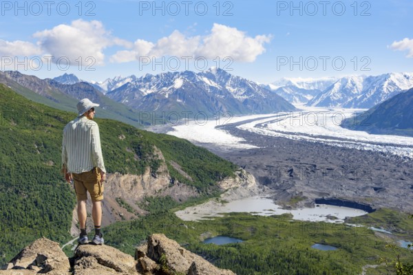 Young man enjoying the view, view of impressive mountain landscape with Matanuska glacier and