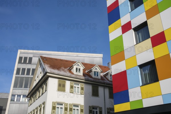 Modern architecture meets historic architecture, city view with colorful facades and clear blue