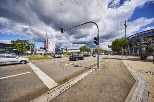 Traffic light crossing, general architecture, train station, sidewalk, cycle path, road, cars,