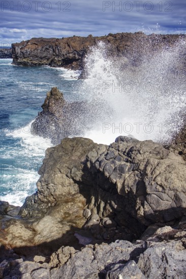 Coastal scene with waves breaking against rocks under a cloudy sky, Playa del Janubio, Yaiza