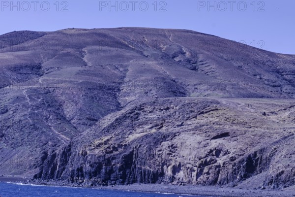 Large rocks and mountains along the coastline that extend into the sea, Playa Quemada, Yaiza
