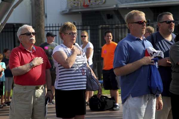 People at the entrance to the Kennedy Space Center during the national anthem, Merritt Island,