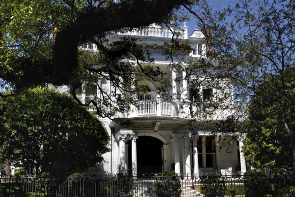 Majestic house with veranda surrounded by trees in the Garden District, New Orleans, Louisiana, USA