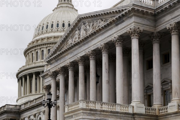 Detailed view of the Capitol with distinctive dome and column-decorated building, Washington D.C,