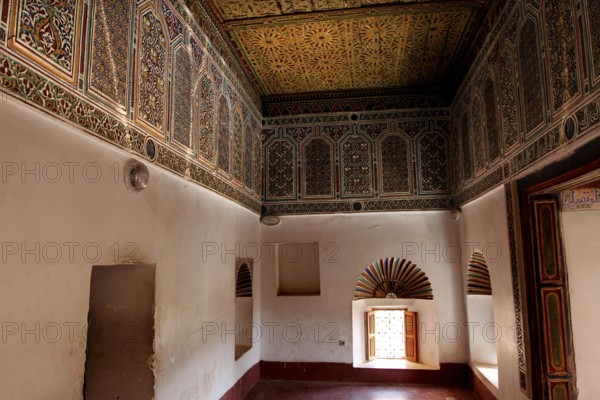 Richly decorated interiors of Kasbah Taourirt with ornate ceilings and traditional Moroccan