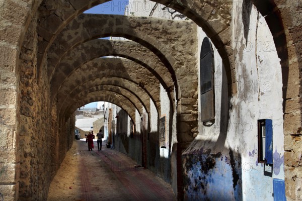Archways with stone structure and atmospheric strips of light in the medina of Safi, Safi,