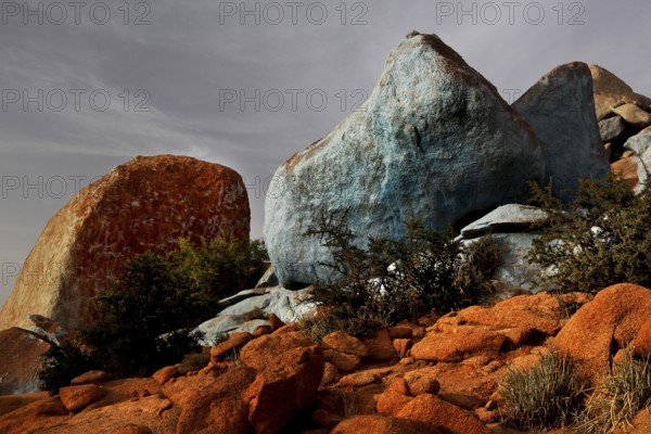 Blue painted stones in the barren desert landscape of Tafraoute by Jean Verame, Tafraoute,