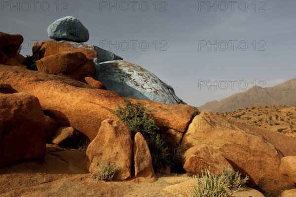 Blue and red rocks by Jean Verame in the desert landscape of Tafraoute, Tafraoute, Souss-Massa,