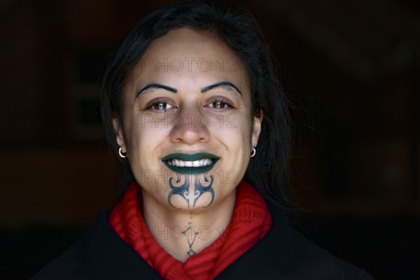 Portrait of smiling person with a Maori tattoo, Rotorua, Te Puia, New Zealand