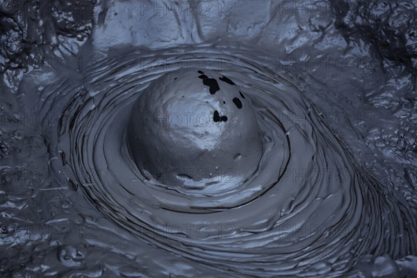 Bubbling mud hole in Whakarewarewa geothermal area, showing raw forces of nature, Rotorua, North