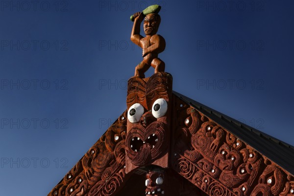 Detailed carved marae roof in Whakarewarewa village, showing traditional Maori architecture,