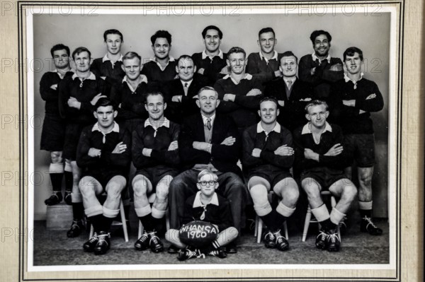 Historical black and white portrait of a rugby team in traditional clothing, Whangamomona, New