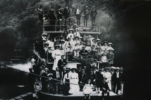 Historical photo of people on a boat on the Whanganui River, Whanganui River, Manawatu-Wanganui,