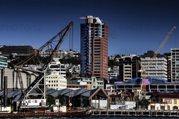 Harbour view with crane and modern buildings on Wellington Waterfront, Wellington, North Island,