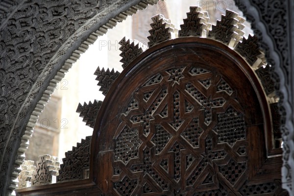 Traditional wooden door with complex Islamic decorations in Medersa Attarine, Fez, Fès-Boulemane,