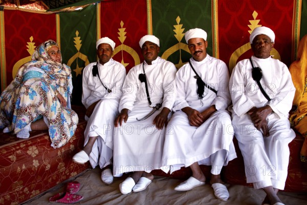 Participants wearing traditional Berber clothing during the Fête des Roses in the participant tent,