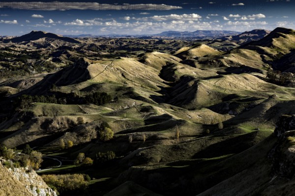 Panorama of Te Mata Peak with extensive mountain landscape under slightly cloudy sky