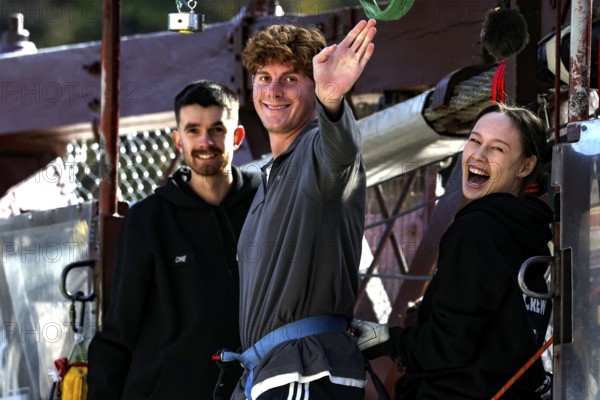 Person in front of bungee jump smiling surrounded by friends at Kawarau Bridge, Queenstown, Kawarau
