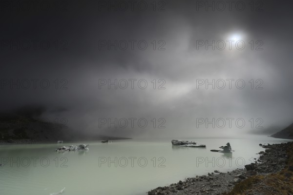 Night view of a glacial lake under cloudy sky in Aoraki National Park, Mt Cook, Hocker Valley