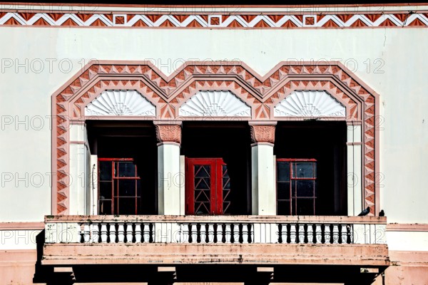 Close-up of an art deco balcony with geometric pattern and red doors, Napier, Hawke's Bay, New