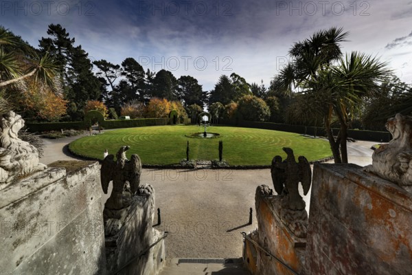 Round garden area in front of Larnach Castle, surrounded by trees and sculptures, Otago Peninsula,