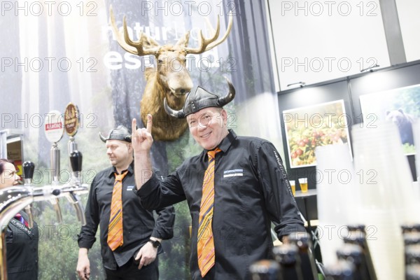 Two men wearing helmets at the Estonian stand at the Green Week at the exhibition center in Berlin