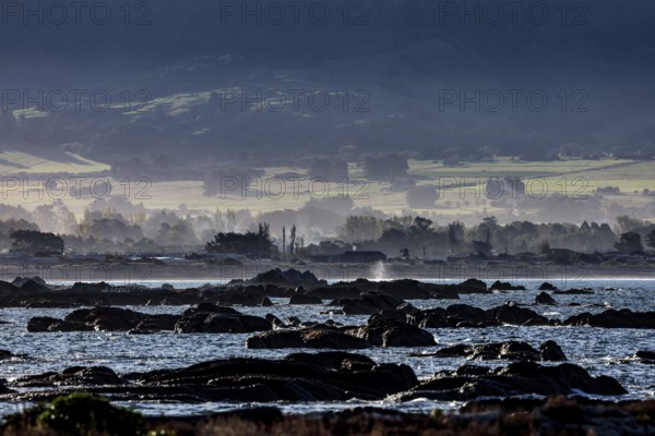 Rocky coastline of Kaikoura with views of water and countryside, Kaikoura, New Zealand