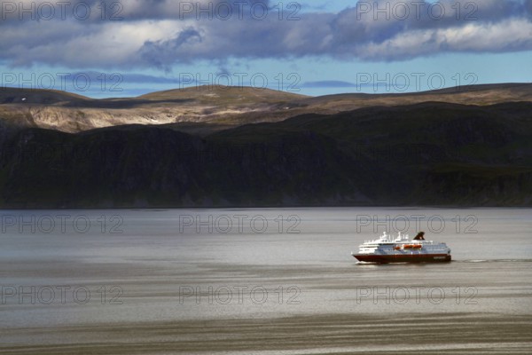 Hurtigruten ship off the coast at Hammerfest, calm seas under cloudy sky, Hammerfest, Finnmark,