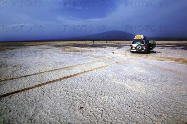 Land cruiser in a barren desert landscape with mountain views, Kusrawad, Ethiopia